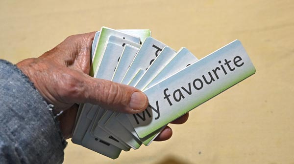 About a dozen Word-Cards held in the hand